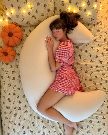 Side sleeper hugging cream crescent moon body pillow