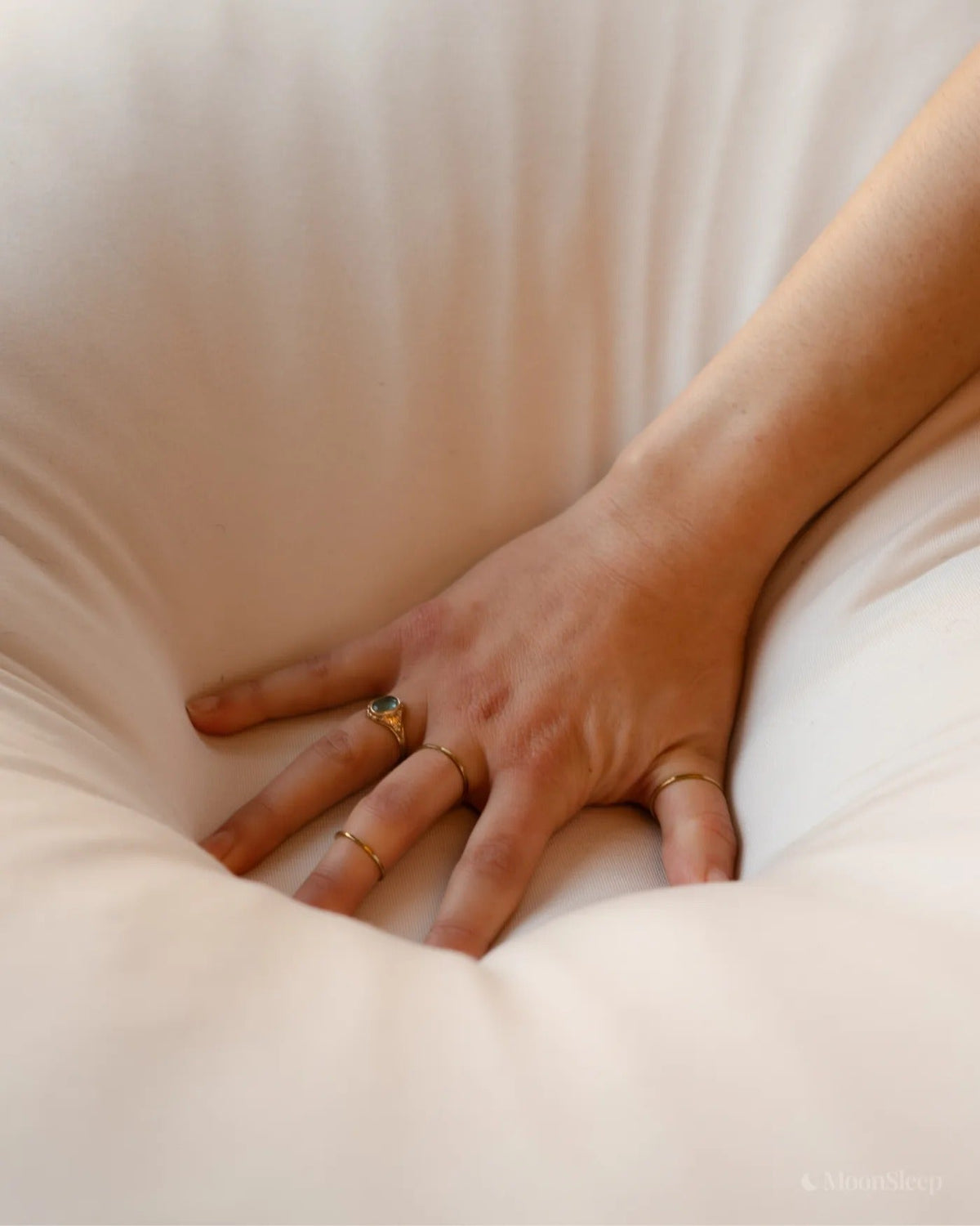Close-up fingers sinking into soft fill