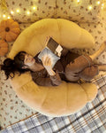 Lounging and reading with crescent body pillow