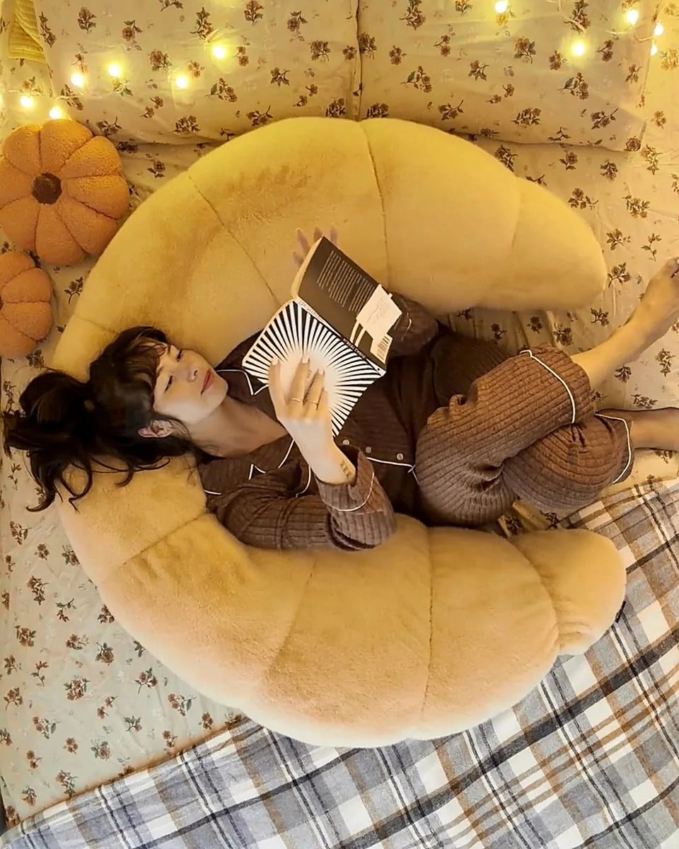 Lounging and reading with crescent body pillow