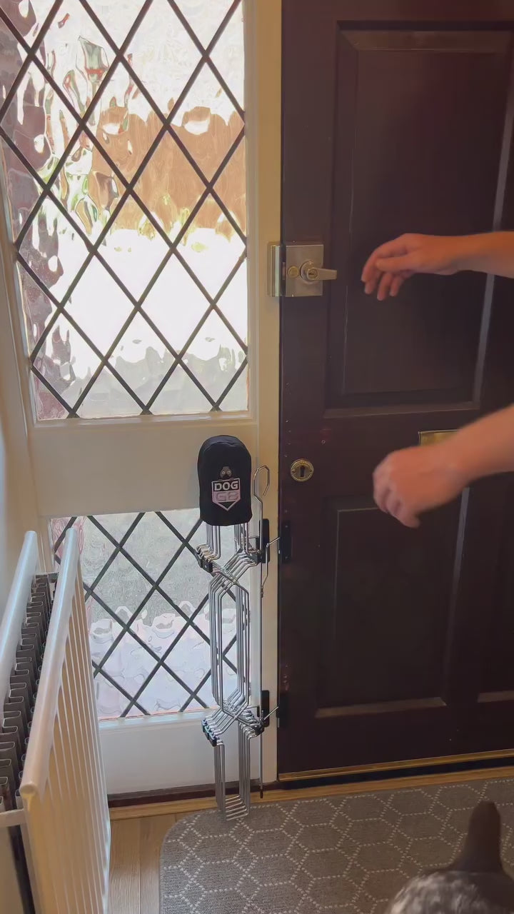 Lifting the locking bar and folding Dog Safety Gate Plus back at the front door